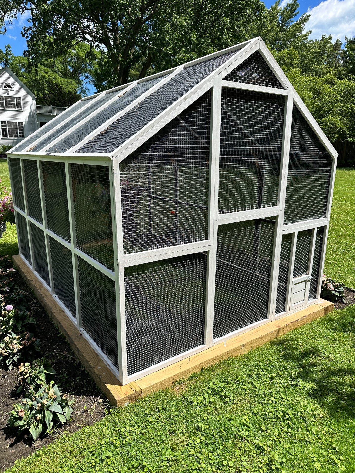 The new 2026 nursery enclosure with white-painted cedar exterior and secure mesh panels